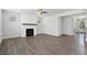 Gathering room with hardwood floors, fireplace, and ceiling fan at 6949 Melody Dr, Buford, GA 30518