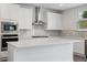 Modern kitchen island with white cabinets and quartz countertop at 6949 Melody Dr, Buford, GA 30518