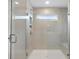 Walk-in shower with glass enclosure and built-in seat at 6949 Melody Dr, Buford, GA 30518