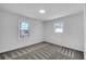 Simple bedroom with gray carpeting and two bright windows at 1536 Daffodil Dr, Marietta, GA 30062