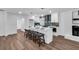 Open concept kitchen island with seating, white cabinets, and a white brick fireplace at 1536 Daffodil Dr, Marietta, GA 30062