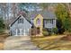 Gray two-story house with stone accents, three-car garage, and landscaped yard at 2410 Emerald Dr, Loganville, GA 30052