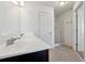 Bathroom with double vanity, shower, and neutral tile flooring at 7633 Summer Berry Ln, Lithonia, GA 30038