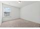 Bright bedroom with carpeted floors and a large window at 7633 Summer Berry Ln, Lithonia, GA 30038