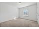 Well-lit bedroom with neutral carpet and large window at 7633 Summer Berry Ln, Lithonia, GA 30038