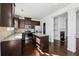 Modern kitchen with island, granite countertops, and stainless steel appliances at 7633 Summer Berry Ln, Lithonia, GA 30038