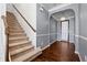 Carpeted staircase with wooden railing in a two-story home at 7633 Summer Berry Ln, Lithonia, GA 30038