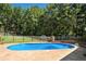 Inviting in-ground pool surrounded by a fenced yard and mature trees at 2784 Sixes Rd, Canton, GA 30114