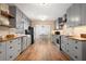 A spacious kitchen with gray cabinets, stainless steel appliances, wood countertops, and wood floors at 2784 Sixes Rd, Canton, GA 30114