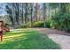 Lush backyard featuring green grass, mature trees, and a serene, private setting at 3090 Karen Ne Ln, Marietta, GA 30062