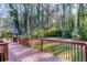 Large wooden deck overlooking a lush, wooded backyard, ideal for enjoying nature and privacy at 3090 Karen Ne Ln, Marietta, GA 30062