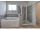 Modern bathroom with soaking tub and glass-enclosed shower at 96 Wentworth Cir, Villa Rica, GA 30180