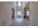 Inviting foyer with soaring ceilings, decorative wall trim, and grey wood-look flooring at 96 Wentworth Cir, Villa Rica, GA 30180