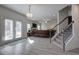 Beautiful living room featuring a fireplace, wood-look floors, staircase, and access to the outside at 96 Wentworth Cir, Villa Rica, GA 30180