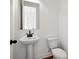 Small bathroom with pedestal sink and toilet at 3879 Allegretto Cir # 116, Atlanta, GA 30339