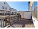 Private outdoor balcony with stained wood floors and aluminum railings overlooking the community at 3879 Allegretto Cir # 116, Atlanta, GA 30339