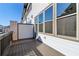Private outdoor balcony with stained wood floors and aluminum railings overlooking the community at 3879 Allegretto Cir # 116, Atlanta, GA 30339