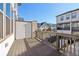 Private outdoor balcony with stained wood floors and aluminum railings overlooking the community at 3879 Allegretto Cir # 116, Atlanta, GA 30339