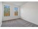 Sunlit bedroom with neutral carpet and two windows offering a pleasant outdoor view at 3879 Allegretto Cir # 116, Atlanta, GA 30339