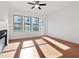 Sunlit bedroom features hardwood floors, a ceiling fan, and a large window with a view at 3879 Allegretto Cir # 116, Atlanta, GA 30339