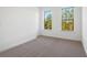 Inviting bedroom with neutral carpet and two windows creating a bright, airy feel at 3879 Allegretto Cir # 116, Atlanta, GA 30339