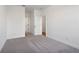 Spacious bedroom featuring neutral carpet, white walls, and a doorway to other rooms at 3879 Allegretto Cir # 116, Atlanta, GA 30339
