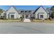 Exterior of a single story white brick clubhouse with black window trim and manicured landscaping at 3879 Allegretto Cir # 116, Atlanta, GA 30339