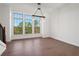 Bright dining area featuring hardwood floors, statement lighting, and large windows offering scenic outdoor views at 3879 Allegretto Cir # 116, Atlanta, GA 30339