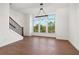Elegant dining area featuring hardwood floors, statement lighting, and large windows offering scenic outdoor views at 3879 Allegretto Cir # 116, Atlanta, GA 30339