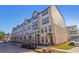 Modern townhome featuring a brick facade, multiple stories, and well-maintained landscaping at 3879 Allegretto Cir # 116, Atlanta, GA 30339