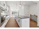 Modern kitchen with stainless steel appliances, white cabinets, and a large center island at 3879 Allegretto Cir # 116, Atlanta, GA 30339