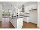Open kitchen featuring an island with seating, stainless steel appliances, and a bright, airy atmosphere at 3879 Allegretto Cir # 116, Atlanta, GA 30339