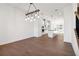 Open-concept space with hardwood floors leading to a modern kitchen and staircase at 3879 Allegretto Cir # 116, Atlanta, GA 30339