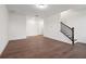 Bright living room with hardwood floors and fresh, white walls and black staircase at 3879 Allegretto Cir # 116, Atlanta, GA 30339