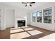 Bright living room features hardwood floors, a ceiling fan, and a fireplace at 3879 Allegretto Cir # 116, Atlanta, GA 30339