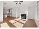Open-concept living area with hardwood floors, fireplace, fan, and seamless flow to the kitchen at 3879 Allegretto Cir # 116, Atlanta, GA 30339