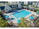Community pool featuring ample seating and lounging options, several shady cabanas, and manicured landscaping at 3879 Allegretto Cir # 116, Atlanta, GA 30339