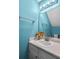 Bright blue half-bathroom with modern vanity, a well-lit mirror, and decorative sunflowers at 4195 Jeanette Ct, Norcross, GA 30093