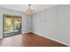 The dining room with neutral walls, laminate flooring and a pendant light has access to the screened in porch at 4195 Jeanette Ct, Norcross, GA 30093