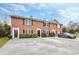 Classic brick townhomes feature black shutters, manicured landscaping, and convenient parking at 4195 Jeanette Ct, Norcross, GA 30093