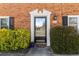 Charming brick home featuring a black front door framed by white trim and decorative shrubs at 4195 Jeanette Ct, Norcross, GA 30093