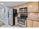 Functional kitchen space with stainless steel oven and refrigerator, enhanced by tile backsplash at 4195 Jeanette Ct, Norcross, GA 30093