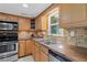 Traditional kitchen with wood cabinets, stainless steel appliances, and mosaic tile backsplash at 4195 Jeanette Ct, Norcross, GA 30093