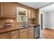 Efficient kitchen layout featuring stainless steel dishwasher and a view into the dining area at 4195 Jeanette Ct, Norcross, GA 30093