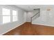 Laminate floors and staircase detail can be seen in this living room with neutral walls and baseboards at 4195 Jeanette Ct, Norcross, GA 30093