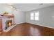 Bright living room with laminate floors, a fireplace, and a large window providing natural light at 4195 Jeanette Ct, Norcross, GA 30093