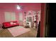 Pink bedroom with vanity, sofa, and large windows at 870 Belmar Pass, Fairburn, GA 30213