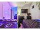 Two twin beds in a bedroom with purple lighting and gaming setup at 5901 Seabright Ln, Atlanta, GA 30349