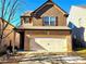 Two-story house with brown siding, beige brick, and a two-car garage at 5901 Seabright Ln, Atlanta, GA 30349