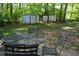 Backyard area with green space, outdoor seating, and storage sheds in distance at 4120 Highway 92, Acworth, GA 30102